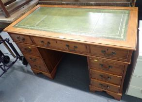A 20thC reproduction writing desk, with two pedestals, each fitted with three drawers, on bracket fe