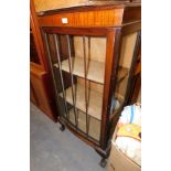 A mahogany bowfront display cabinet, with striped astragal glazed doors, on outsplayed ball and claw