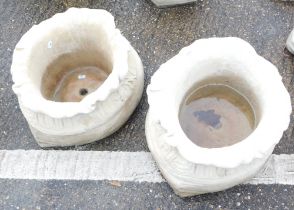 A pair of large sack shaped planters, each with a fluted top and bow design, 24cm high, 41cm wide. (