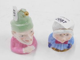 Two Royal Worcester porcelain candle snuffers, comprising baby and Punch.