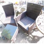 A woven garden set, comprising two chairs and glass top coffee table.