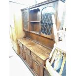 A mahogany kitchen dresser, with central bookshelf section, two glazed doors, on shelf top above thr