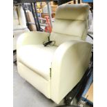 A cream leatherette electric reclining single armchair.