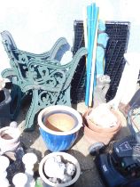 Various cast iron bench ends, together with dog crate, terracotta plant pots, garden statues, etc.