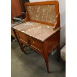 An Edwardian marble topped wash stand, the moulded back inset with marble, on a rectangular top abov