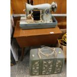 A teak sewing machine table and a cased blue Jones sewing machine.