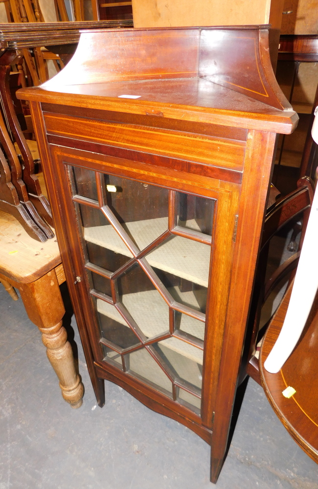 A mahogany corner display cabinet, with an arched and moulded cornice, above single astragal glazed