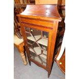 A mahogany corner display cabinet, with an arched and moulded cornice, above single astragal glazed