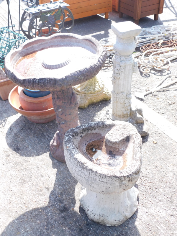 A concrete birdbath, 63cm high, another 40cm high, and a garden plinth. Buyer Note: VAT payable on