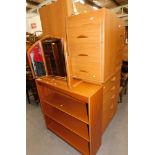 A group of beech effect bedroom furniture, comprising a five drawer chest, two bedsides, bookcase, d