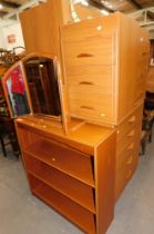 A group of beech effect bedroom furniture, comprising a five drawer chest, two bedsides, bookcase, d