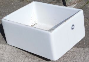 A ceramic Belfast sink, 58cm wide.