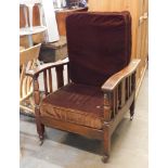 An oak steamer chair, with two brown cushions. The upholstery in this lot does not comply with the