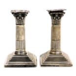 A pair of George V loaded silver Corinthian column candlesticks, Chester 1913, 25.29oz all in, 16cm