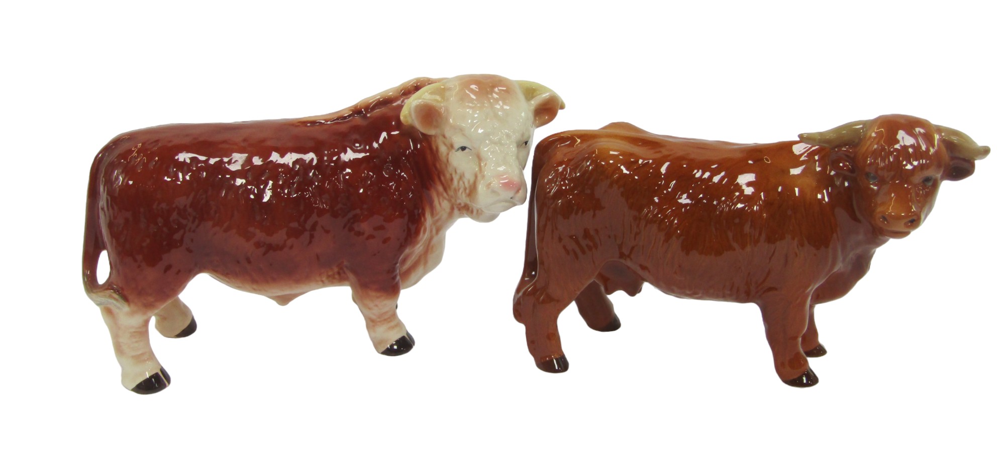 A Melba ware pottery figure modelled as a bull, 15cm high, and a Highland Cow, 16cm high.