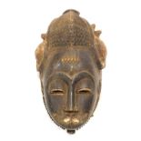 Tribal Art. Baule Mblo portrait mask with highly stylized coiffure and scarifications, Cote D'Ivoire