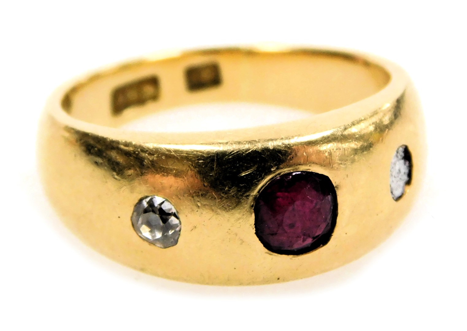 A ruby and diamond three stone gypsy ring, one diamond lacking, set in yellow metal, stamped 18ct,