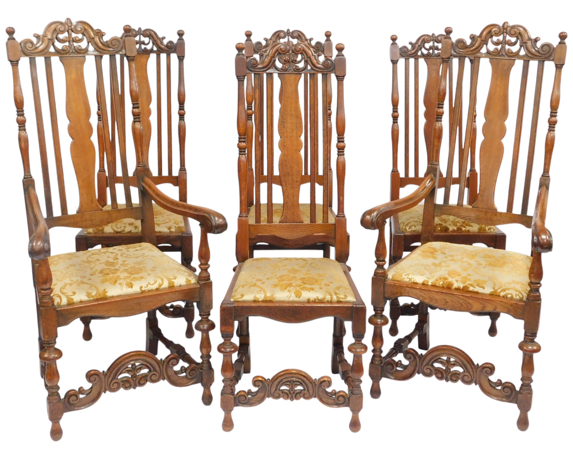 A set of six 20thC oak dining chairs, each with a carved and pierced back, drop in seat, on turned