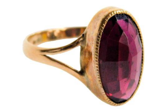 An oval cut amethyst solitaire ring, in a rose metal setting, size M, 2.7g. - Image 1 of 2