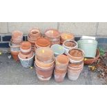 A quantity of terracotta plant pots, of various sizes.