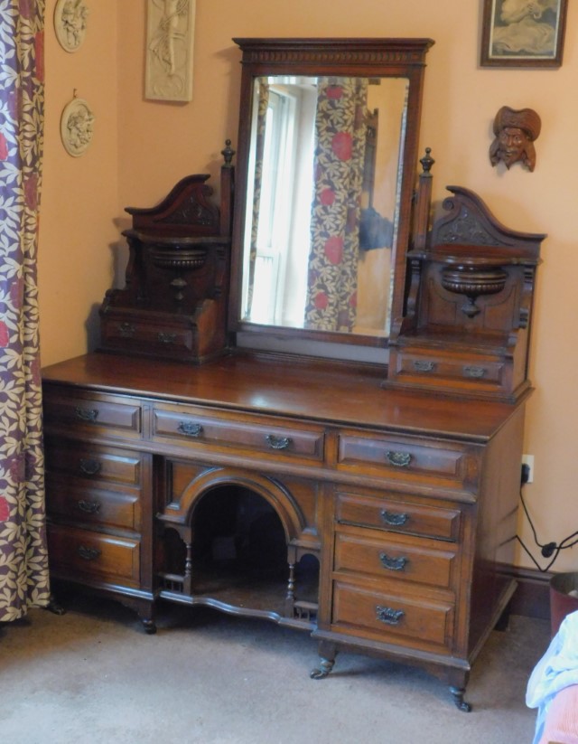 A Victorian walnut dressing table, with bevelled plate mirror, support panels with drawers and a