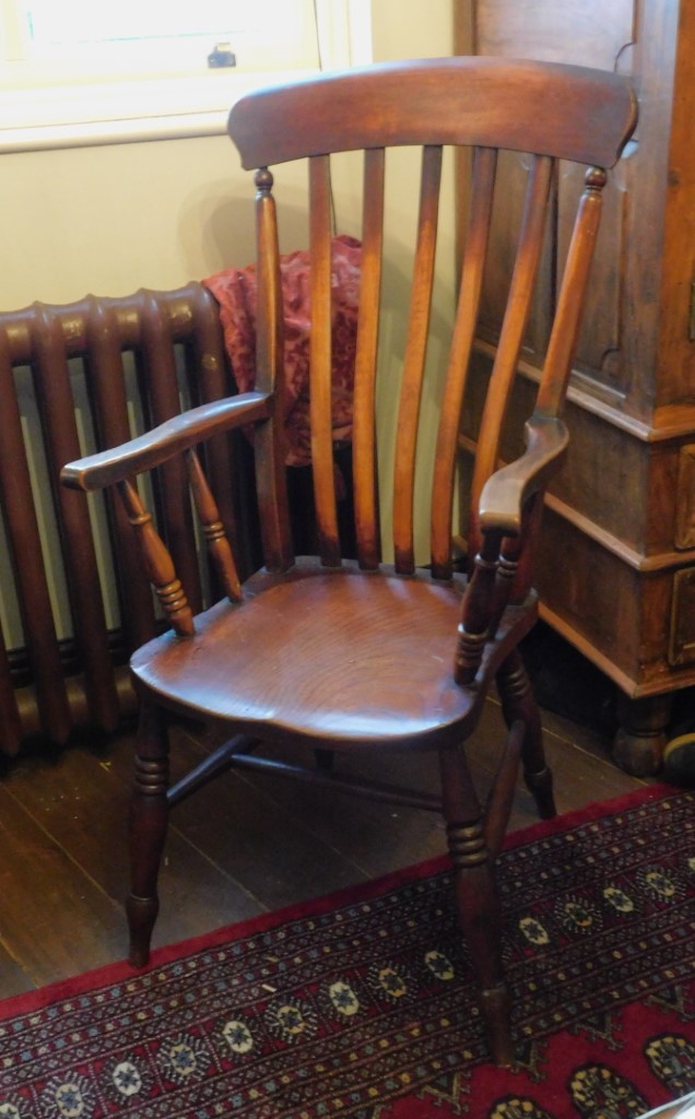 A lath back Grandfather chair, with a solid seat, on turned legs with H stretcher. This lot is