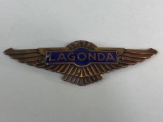 Aston Martin Lagonda bonnet badge being bronze out stretched wings with blue enamel Lagonda plaque