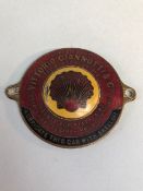 Enamel car dealership plaque, red and yellow enamel depicting a shell in the middle, Supplied By