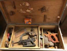 Wooden chest containing various woodworking tools including saws, clamps, hammers etc