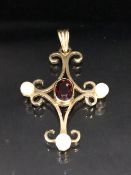 9ct gold pendant in the form of a cross and set with pearls and a central oval garnet approx 3.5 x