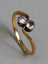 Antique 18ct yellow gold ring mounted with 2 diamonds in a cross over design, approximately K 1/2