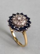 18ct yellow gold Diamond and Sapphire Daisy style ring. A central diamond surrounded by a ring of