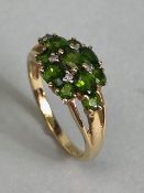 9ct Gold ring set with green Tourmaline gemstones with pierced shoulders size approx 'M'