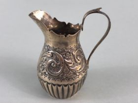 Victorian Silver hallmarked cream jug with repousse design and lower half fluted design hallmarked