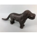 Antique cast Iron dog nut cracker, the tail leaver stamped Made in England along with an illegible