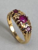 18ct Gold ring set with red/pink gemstones size approx 'L' & 3.7g