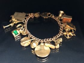 9ct Gold Charm Bracelet with approx seventeen charms to include Cupid, a British Passport, Archer,