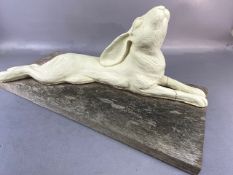 Art pottery, ceramics, life size sculpture of a hare lying down and staring at the sky mounted on