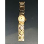 9ct Gold Ladies wristwatch with 9ct Gold gate link bracelet strap, the watch face marked 17 RUBIS