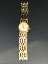 9ct Gold Ladies wristwatch with 9ct Gold gate link bracelet strap, the watch face marked 17 RUBIS