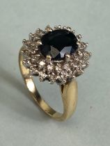 9ct Gold Sapphire and Diamond cluster ring the central faceted Sapphire approx 7.5 x 9mm and size '