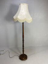 Antique style wooden turned standard lamp base with shade approximately 190cm overall