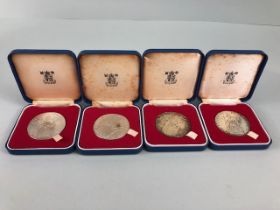Collection of four 1977 The Queens Silver Jubilee Crown coin or medals from the Royal Mint boxed