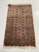 Vintage Pakistan Bokhara Rug Dusky pink background with typical geometric patterns to centre and