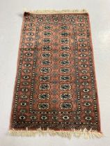 Vintage Pakistan Bokhara Rug Dusky pink background with typical geometric patterns to centre and