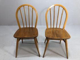 Mid century furniture, two Ercol 1960s blonde hoop back stick dining chairs, registration marks