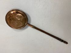 Antique copper bed warming pan with chased decoration to front, turned wooden spindle handle