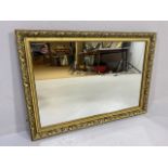 Mirror, modern mirror in a Gilt frame of leaf and berry design approximately 86 x 61cm