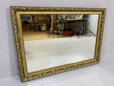 Mirror, modern mirror in a Gilt frame of leaf and berry design approximately 86 x 61cm