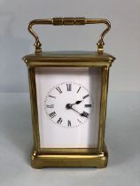 Antique style brass four glass panel chiming carriage clock, white face with roman numerals,